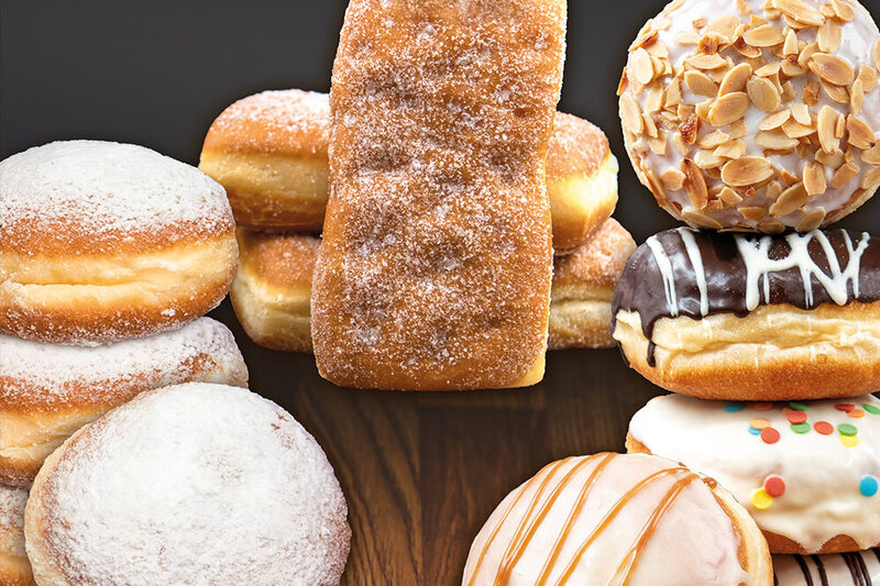 Bild zeigt verschiedene Berliner-Sorten mit Puderzucker oder bunt glasiert.